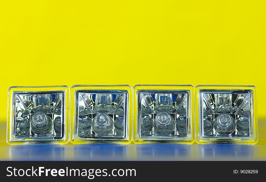 Four decorative atypical square halogen light bulbs laying on side isolated on gradient background. Four decorative atypical square halogen light bulbs laying on side isolated on gradient background