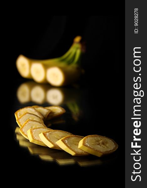 Still life mature cut bananas on black background with clipping path