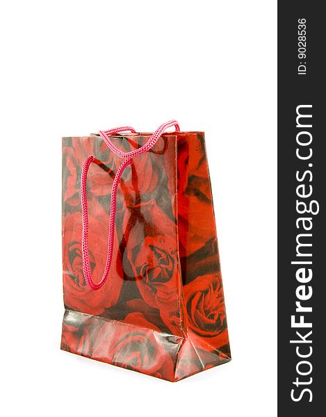 Little black gift bag with red roses isolated on white. Little black gift bag with red roses isolated on white