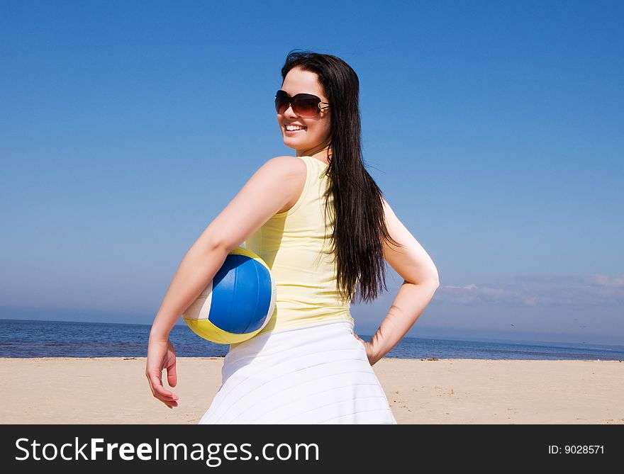 Beautiful woman playing volleyball at the beach