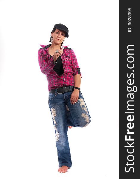 Portrait of a young woman wearing a pink shirt and ripped blue jeans. She is showing a key!. Portrait of a young woman wearing a pink shirt and ripped blue jeans. She is showing a key!