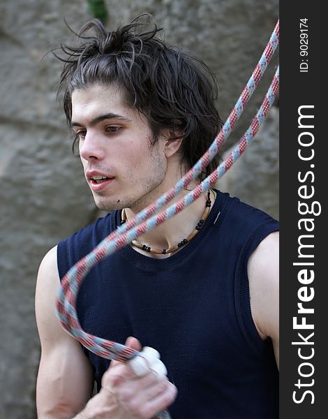 Young man holding climbing rope