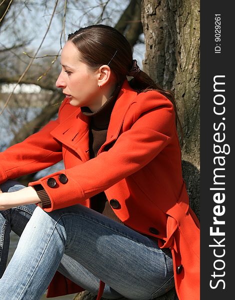 Woman sitting outdoor in a foul mood. Woman sitting outdoor in a foul mood