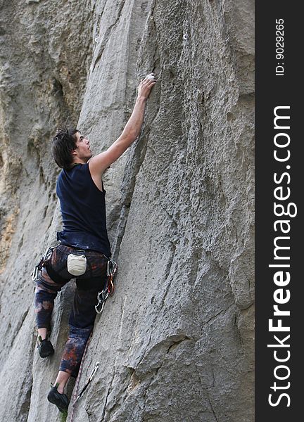 Climber in action on limestone rock