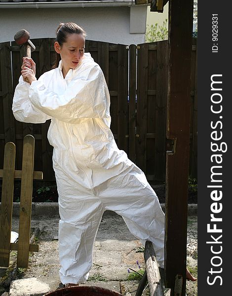 Female worker with hammer outdoor