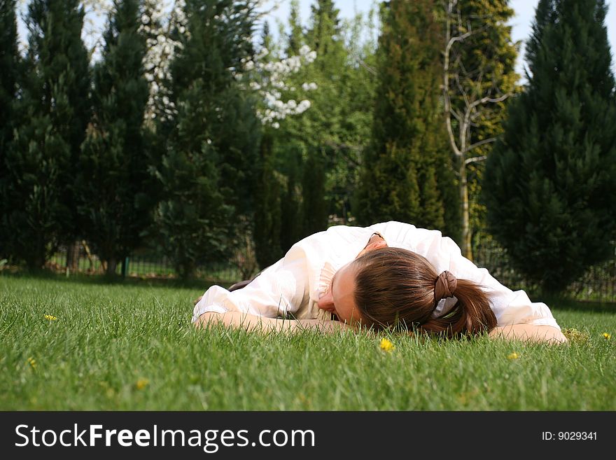 Woman relaxing in garden by the sun