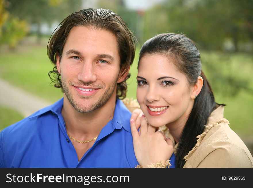 Portrait of two happy couple with background park. Portrait of two happy couple with background park