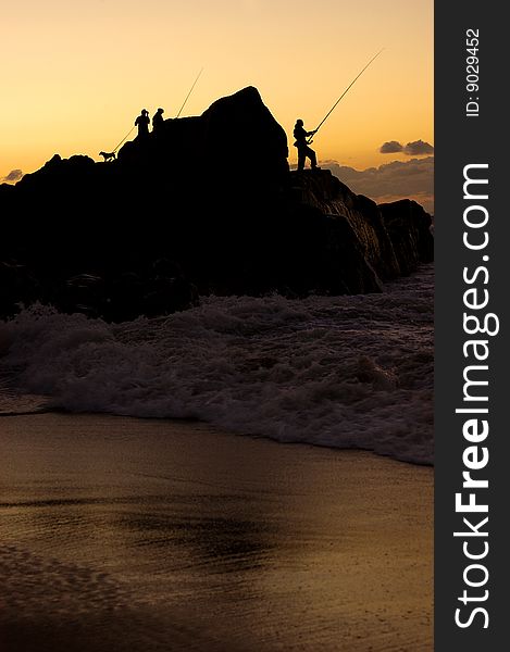 The silhouette of fisherman at the sea. The silhouette of fisherman at the sea