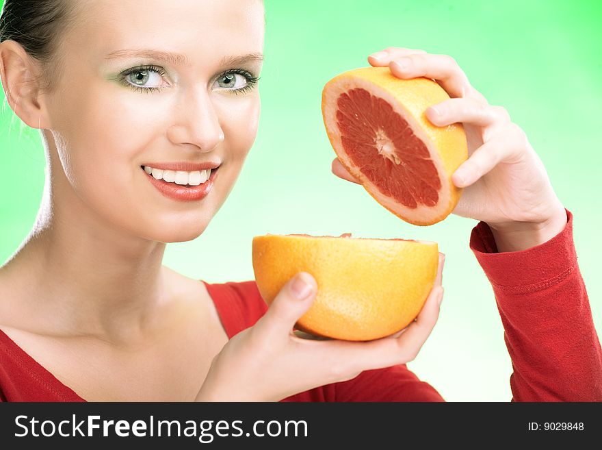 Young beauty woman with grapefruit on green background. Young beauty woman with grapefruit on green background