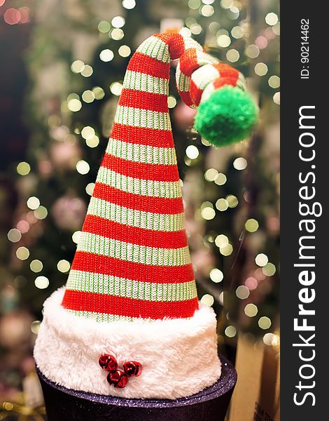 Close up of striped Santa Claus stocking hat decoration with bokeh Christmas lights. Close up of striped Santa Claus stocking hat decoration with bokeh Christmas lights.