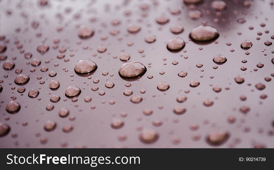 Close up of water drops on metal surface.