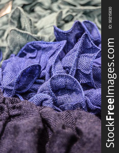 Crumpled grey, blue and purple fabric pieces. Crumpled grey, blue and purple fabric pieces.