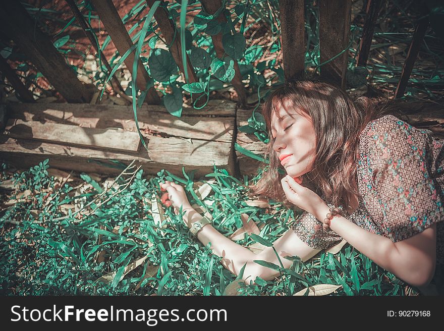 A woman lying in her garden among the plants. A woman lying in her garden among the plants.