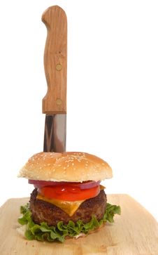 Cheeseburger With Knife In It Stock Photo Cheeseburger With Knife In It Stock Photo