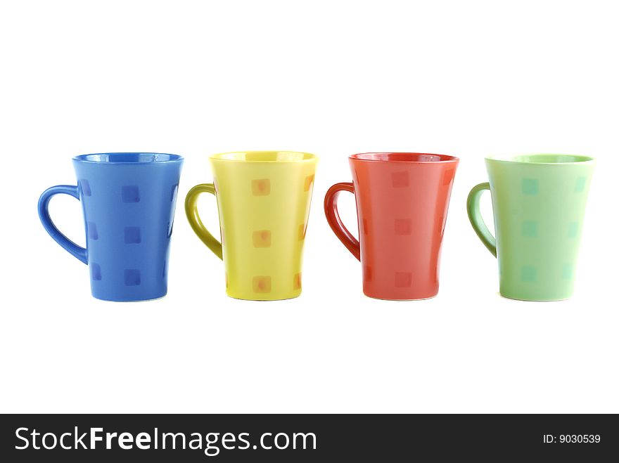 Colour cups for tea and coffee. A small white teapot. Colour cups for tea and coffee. A small white teapot.