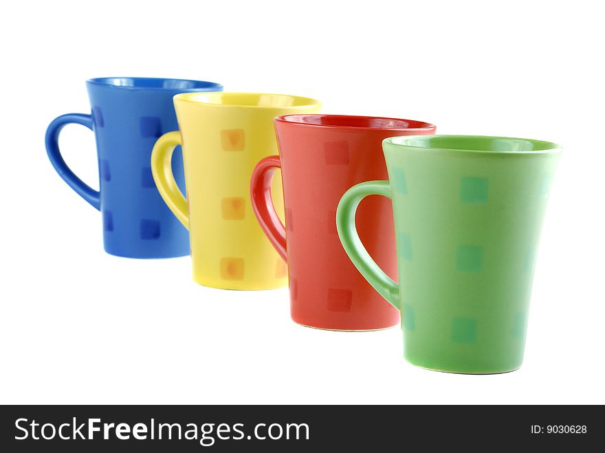 Colour cups for tea and coffee. A small white teapot. Colour cups for tea and coffee. A small white teapot.