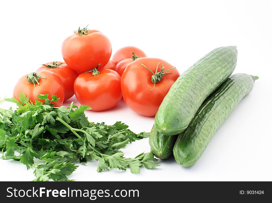 Cucumbers and tomatoes on the white background