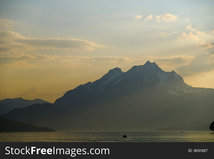 Scenic view of lake Lucerne with Alps mountains in background under cloudscape, Switzerland. Scenic view of lake Lucerne with Alps mountains in background under cloudscape, Switzerland.