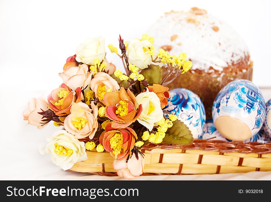 Easter cake with colorful eggs and flowers over white. Easter cake with colorful eggs and flowers over white