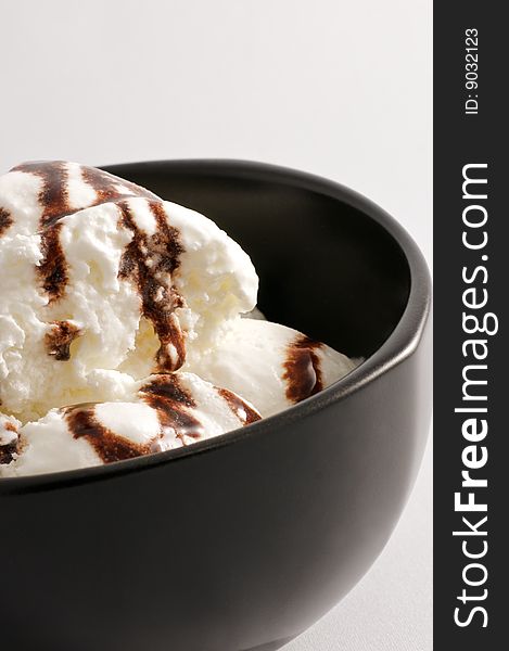 Vanilla ice cream in a black bowl