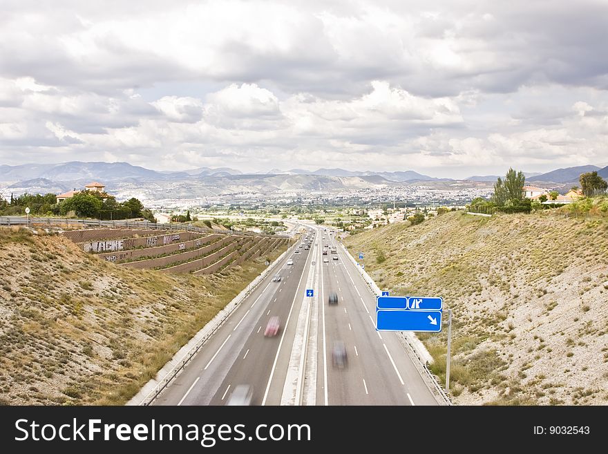 Highway to the city, blank blue sign in one side. Highway to the city, blank blue sign in one side.