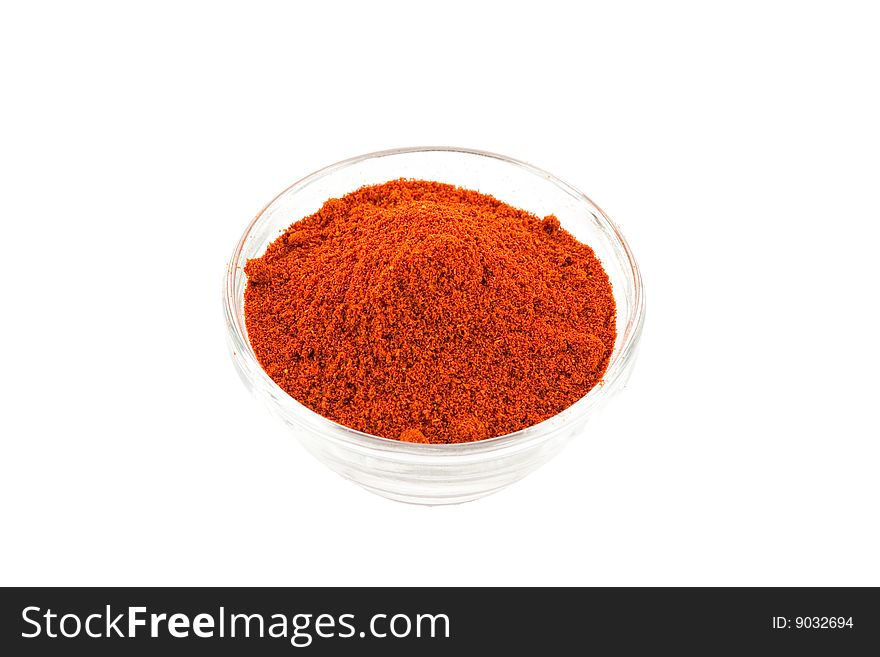 Paprika powder in glass bowl, white background