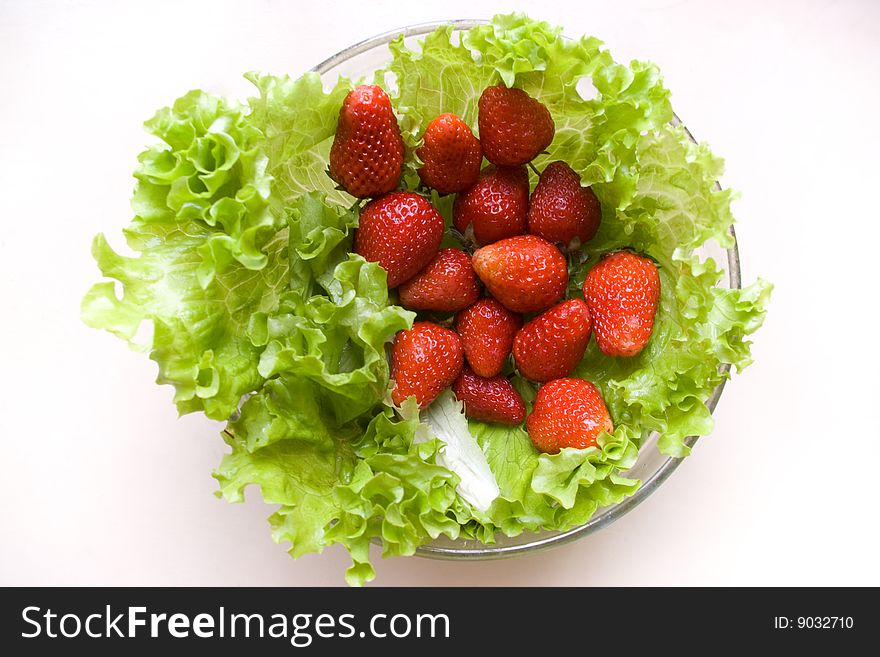 The delicious salad of crisp lettuce and strawberris. The delicious salad of crisp lettuce and strawberris.