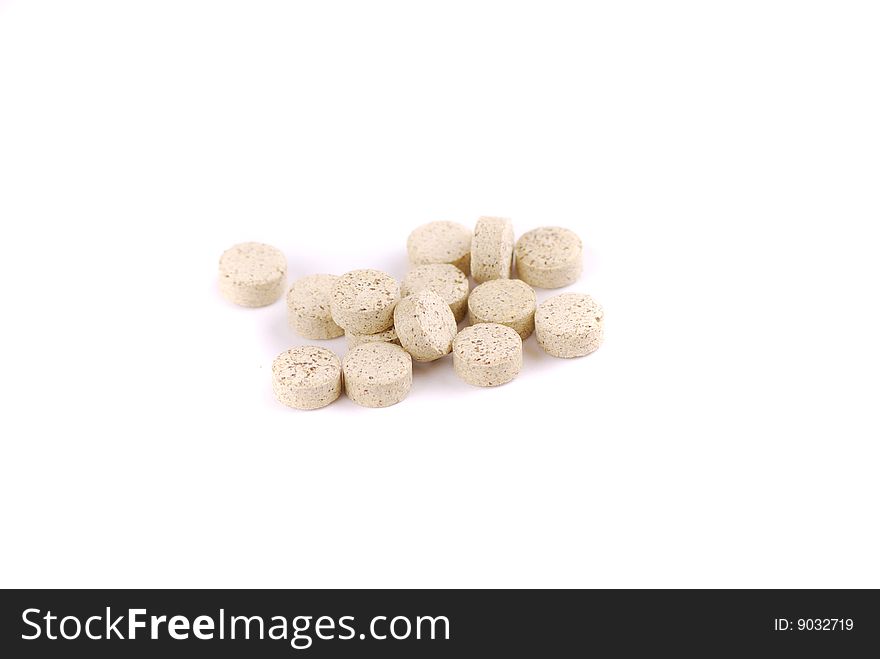 Tablets of various colour on a white background. Food additives.