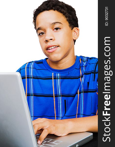 Teenage boy using a laptop isolated over white. Teenage boy using a laptop isolated over white