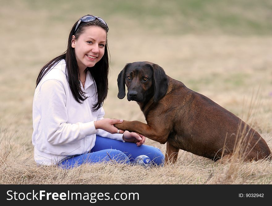 Smiling young girl with her dog outdoor. Smiling young girl with her dog outdoor.