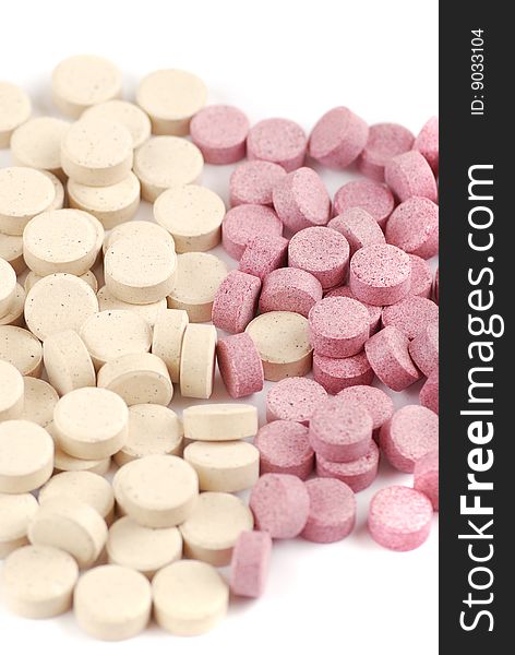 Tablets of various colour on a white background. Food additives.