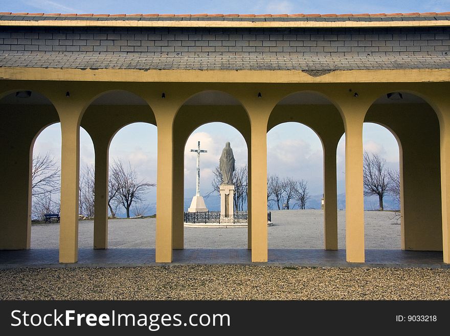 Statue of Immaculate Maria and the cross. Statue of Immaculate Maria and the cross