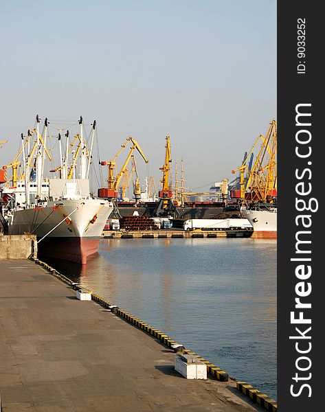 Dry-cargo ships at moorings in harbour of trading port. Dry-cargo ships at moorings in harbour of trading port