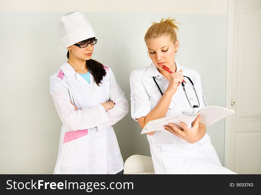 Portrait of a young thoughtful doctor with her assistant in the office