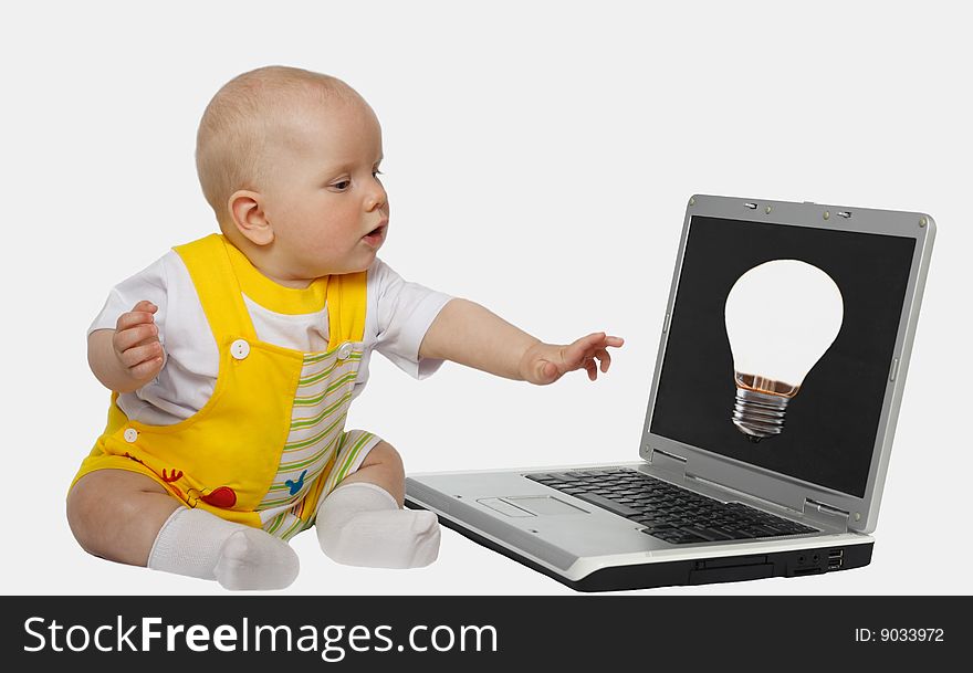 Little girl touching screen on the laptop
