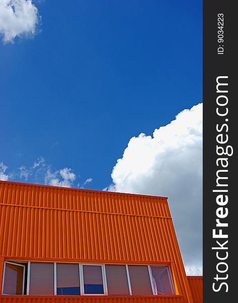 Orange building with cloudy sky