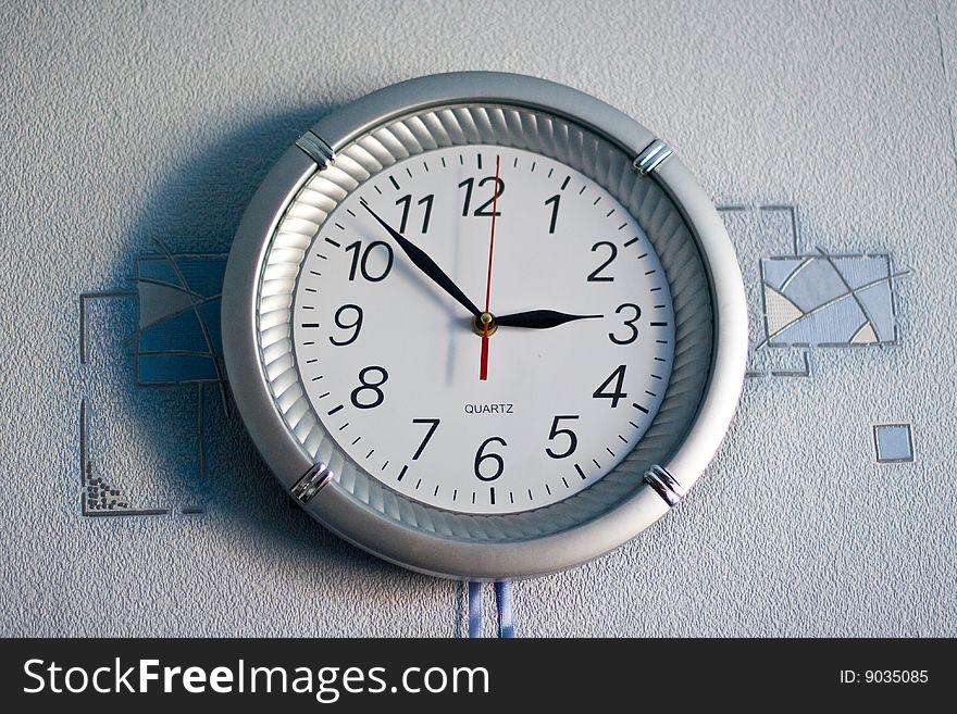 Wall clock on blue background