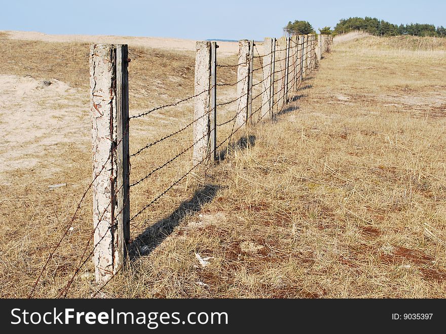 Old barbed wire on a field