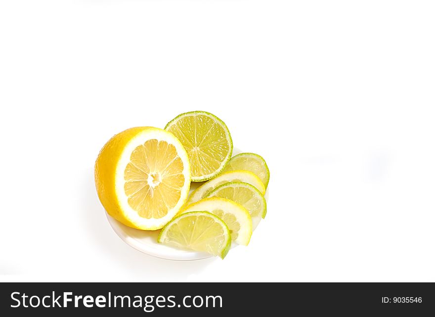 Slices of lemon and lime on saucer isolated over white. Slices of lemon and lime on saucer isolated over white.