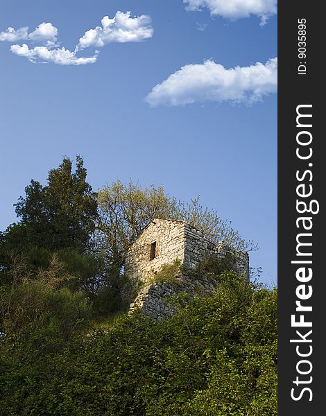 An old house on the very top of a mountain surrounded by the wild nature. An old house on the very top of a mountain surrounded by the wild nature