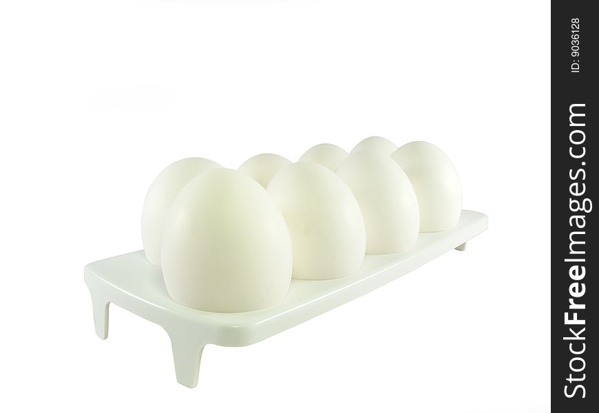 Eight white eggs on a support