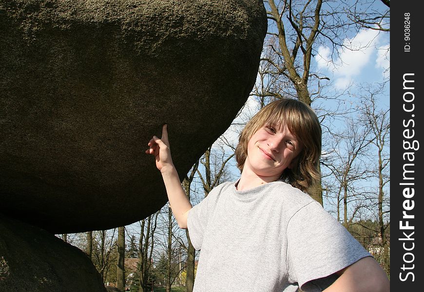 One smilling boy with a big stone. One smilling boy with a big stone