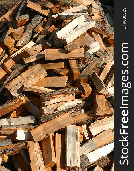 Heap of firewoods as background display pattern or illustration to the concept old types of fuel