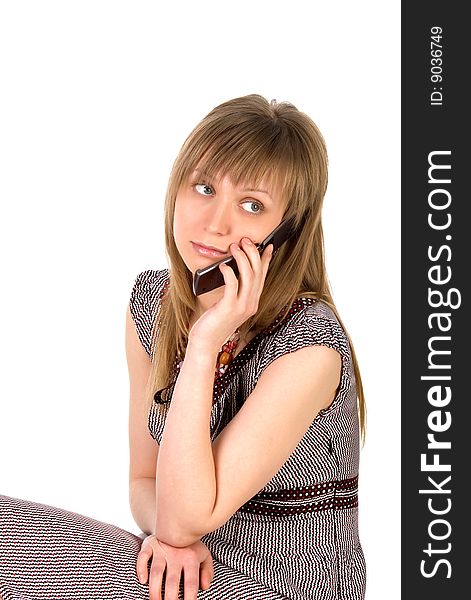 Pretty young woman listens on a mobile phone