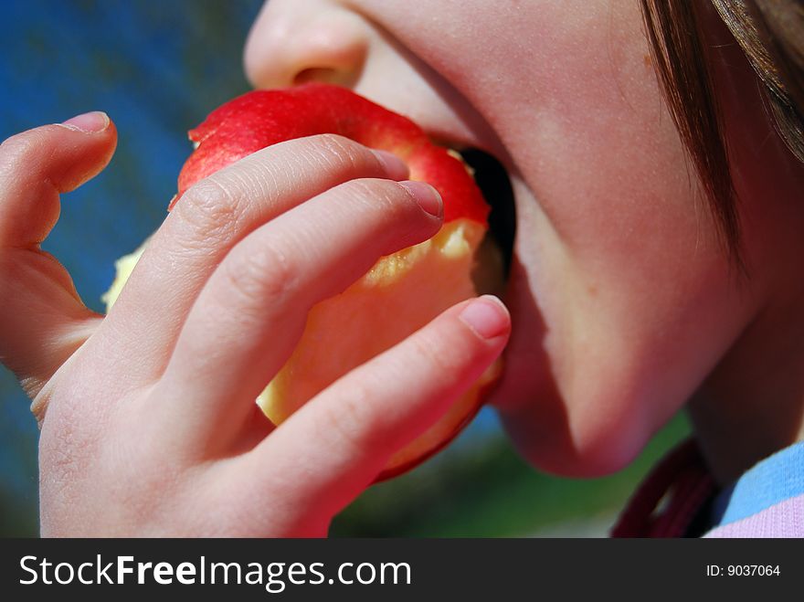 Kid bites an apple. outdoor. Kid bites an apple. outdoor