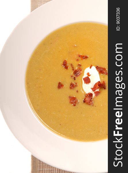 Homemade split pea soup with sour cream and bacon