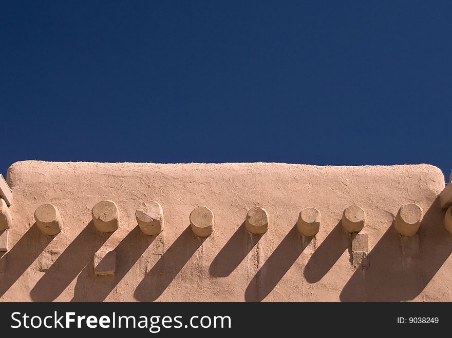 Adobe building roof view with blue sky behind for copyspace. Adobe building roof view with blue sky behind for copyspace