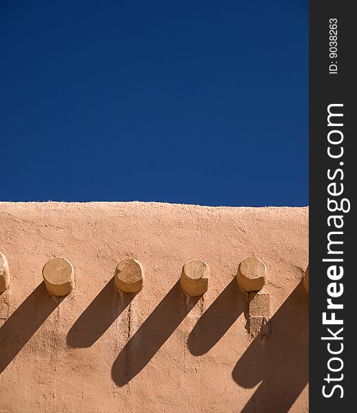 Adobe building roof view with blue sky behind for copyspace. Adobe building roof view with blue sky behind for copyspace