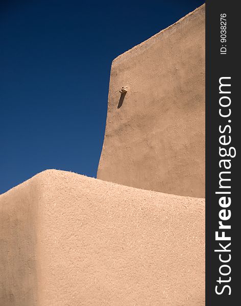 Adobe building roof view with blue sky behind for copyspace. Adobe building roof view with blue sky behind for copyspace