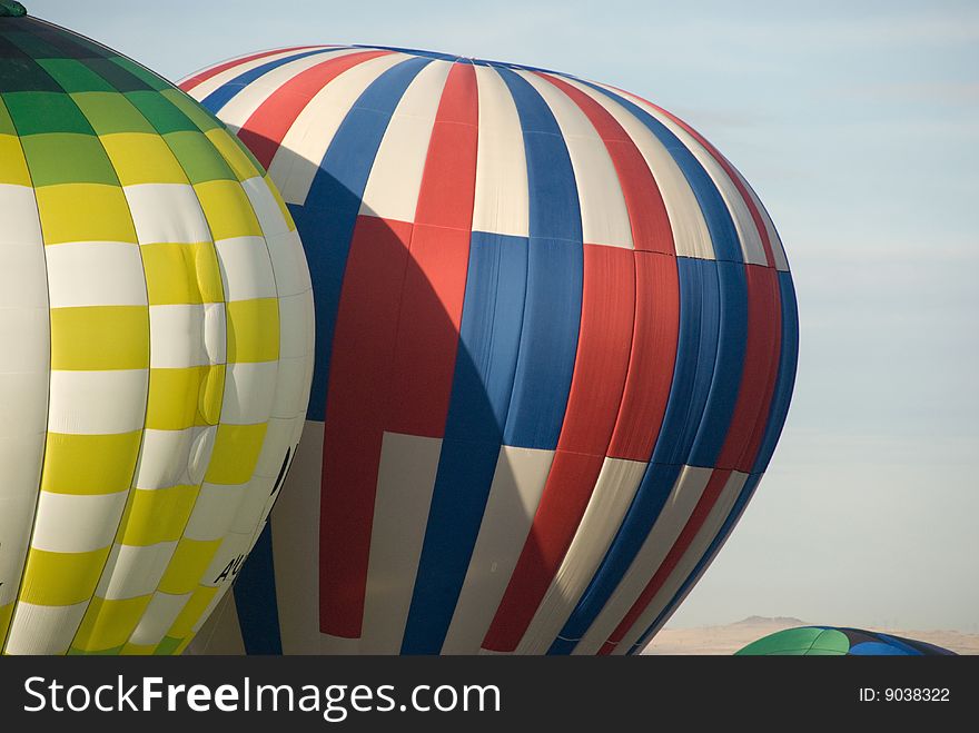 Two hot air balloons with a blue sky background